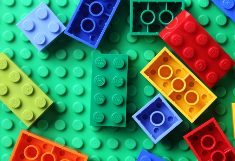 Photo of multicolored LEGO blocks on a green LEGO plate