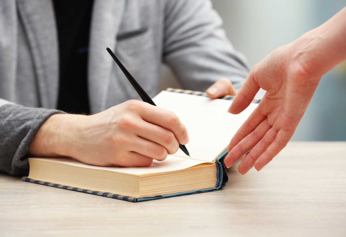 Person signing a book